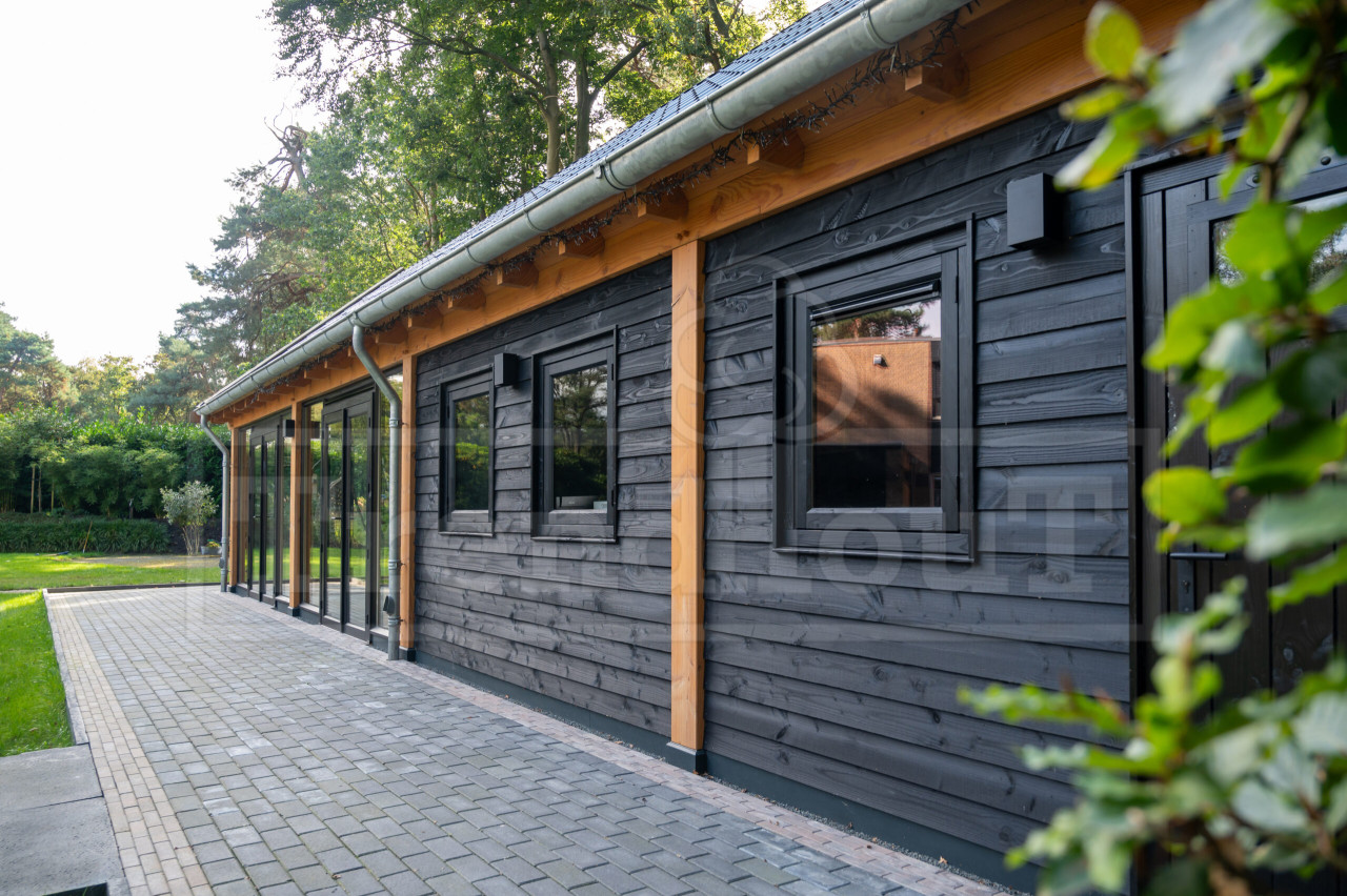 Trendhout-buitenverblijf-zadeldak-xxl-tuinkamer-schuur-zolder-douglas-zwarte-potdekselwanden-steellook-ramen