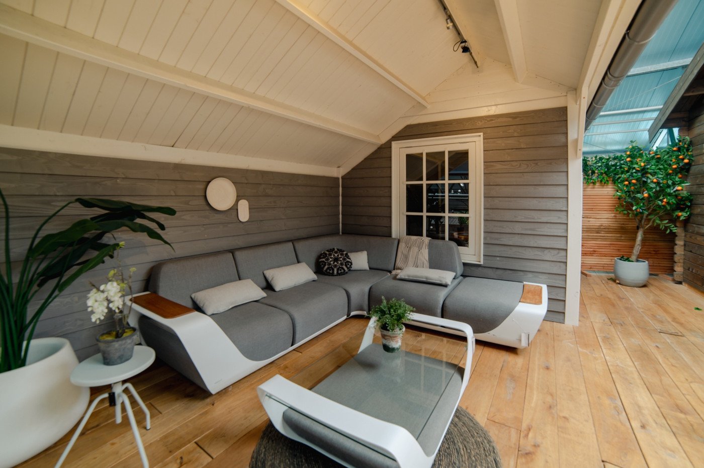 Ingerichte houten veranda met zithoek in showroom